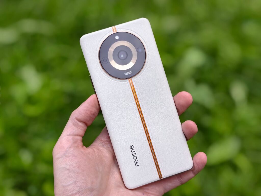 Close-up of a hand holding a modern smartphone outdoors