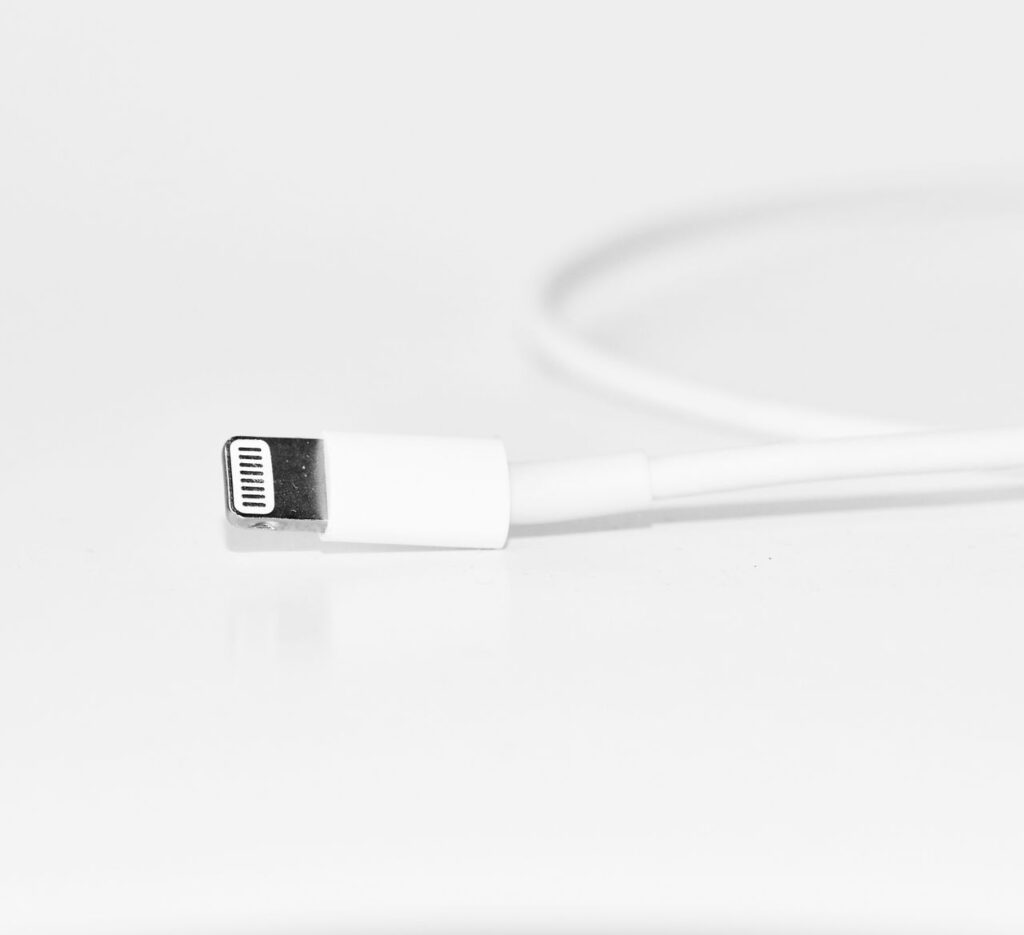 Close-up of a white phone charging cable