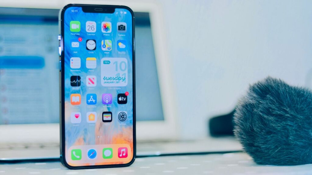 Close-up of an iPhone screen showing apps and the time
