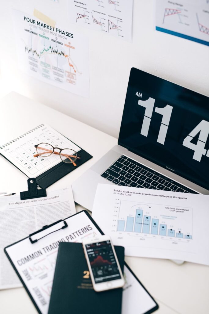 Desk with a laptop, phone and paper documents
