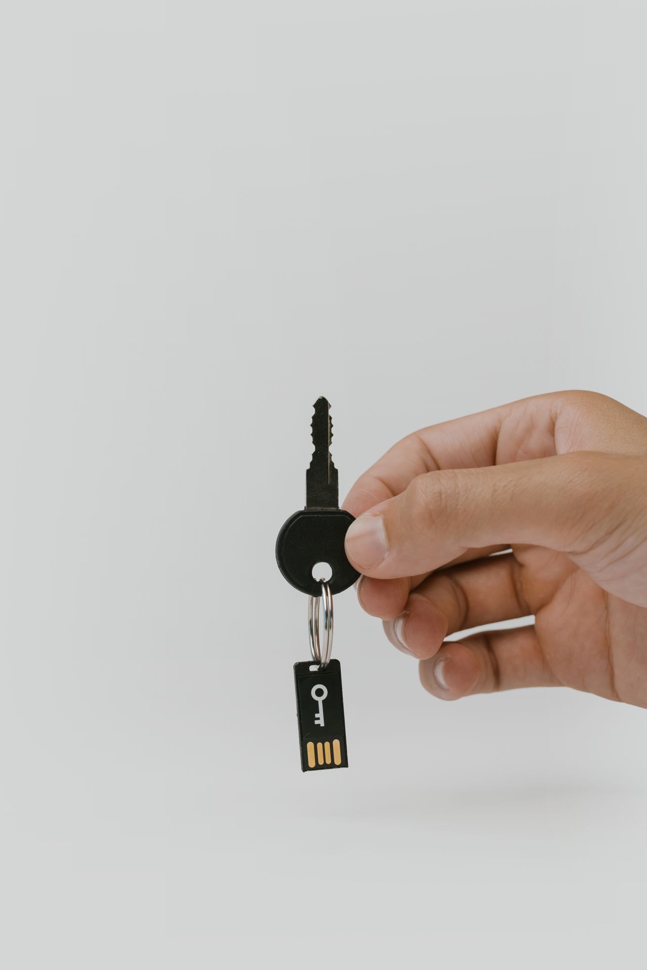 Hand holding a key with a USB security drive