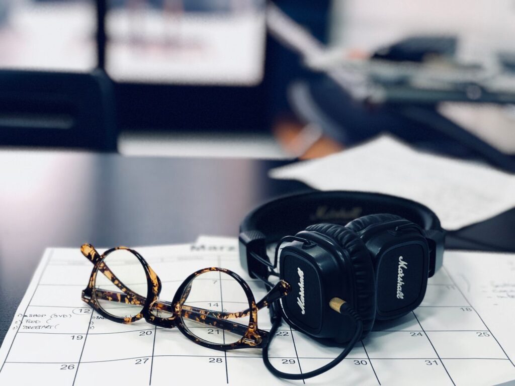 Headphones and glasses on a desk