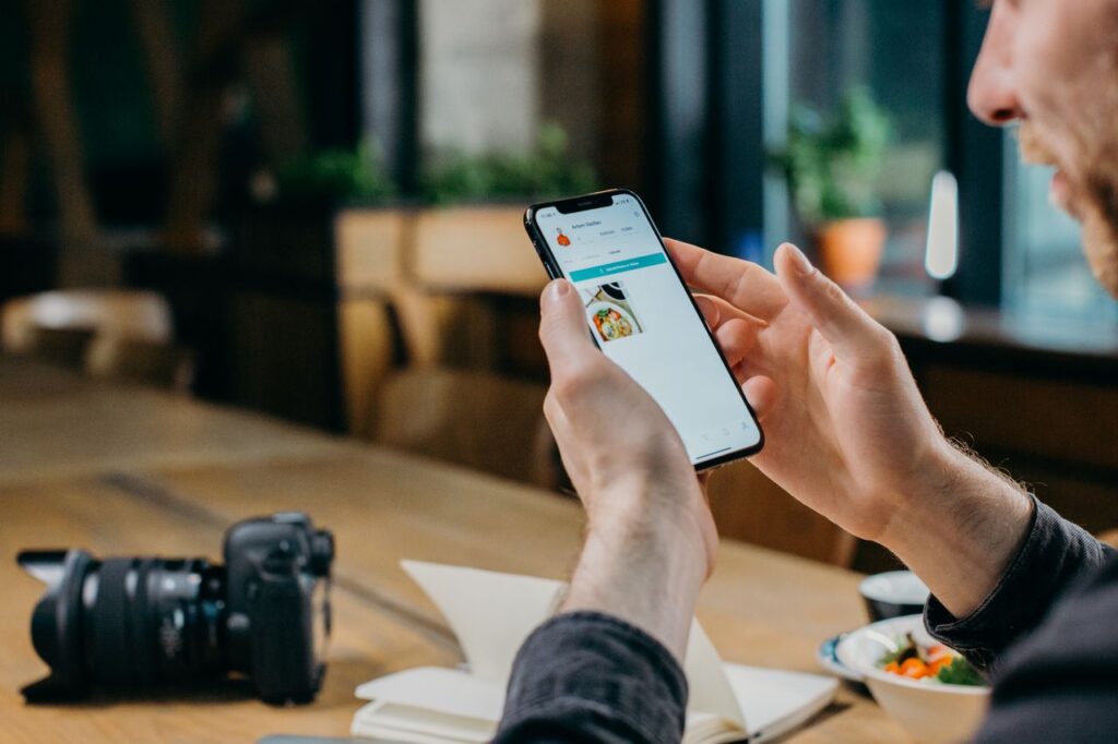 Man using his smartphone in a modern workspace