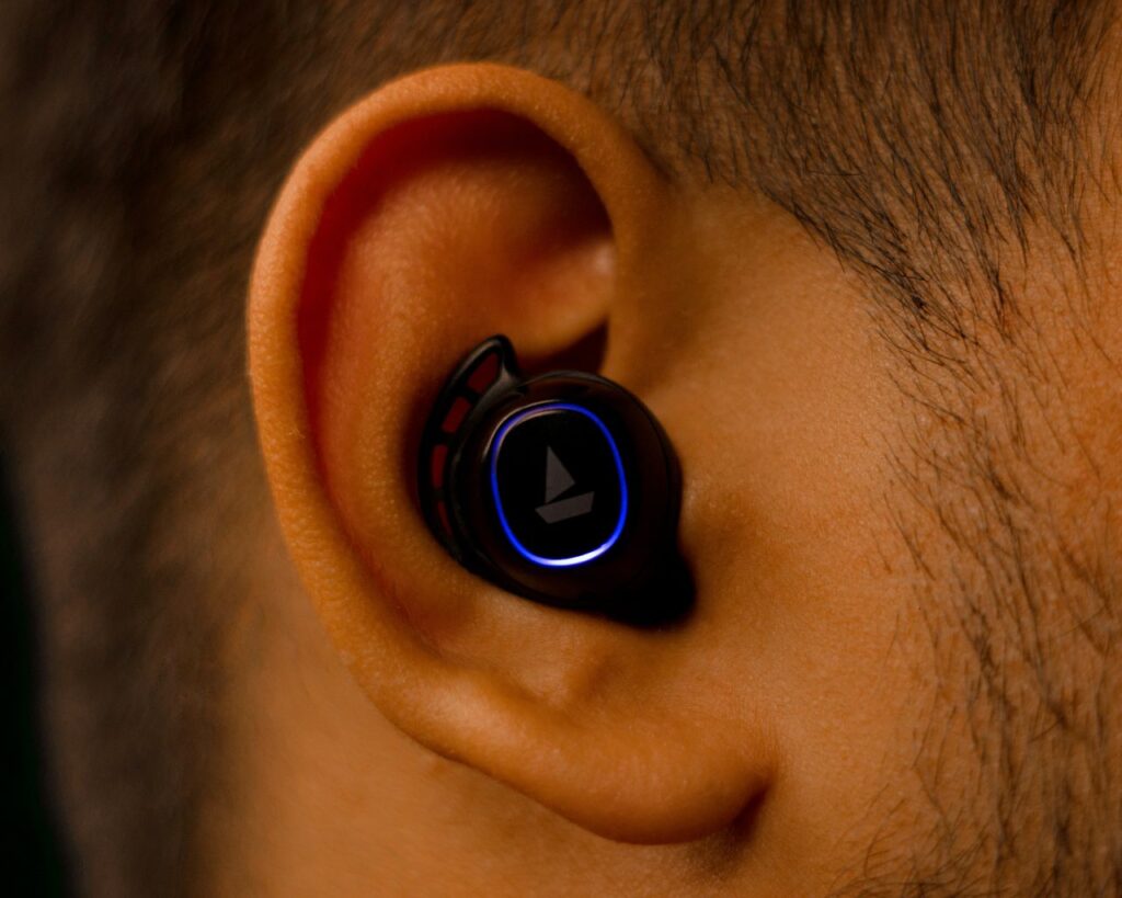 Man wearing a wireless earbud while listening to music