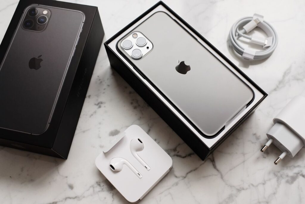 New smartphone in its box with charging cable and earphones