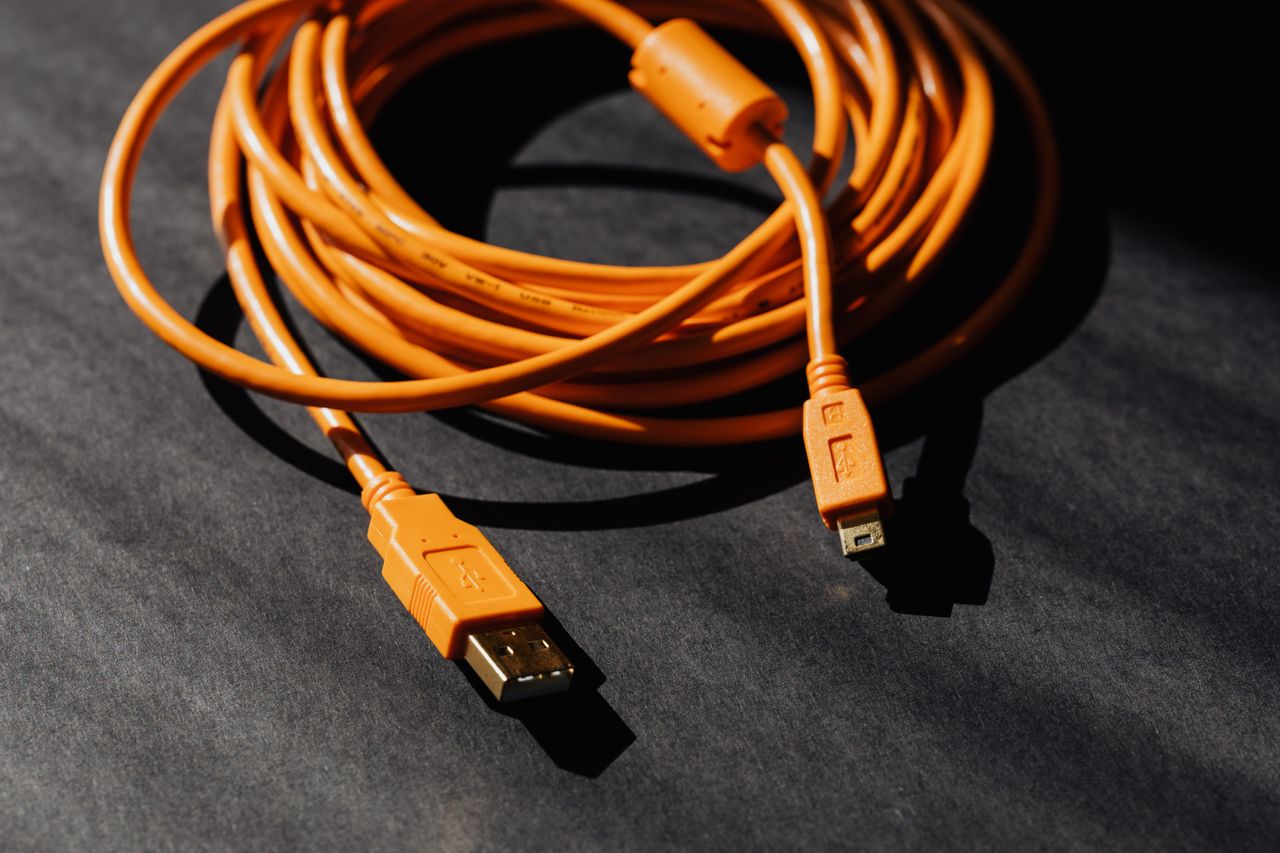 Orange USB charging cable on a dark surface