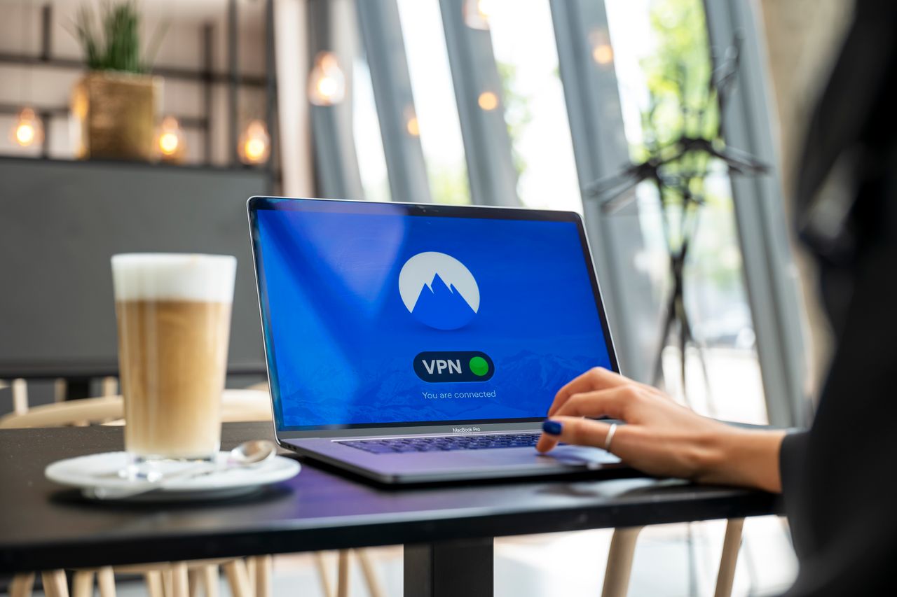 Person using a laptop in a modern cafe