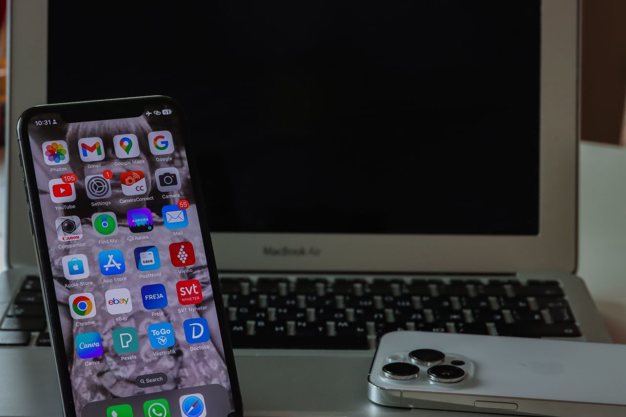 Smartphone and laptop on a desk ready for a backup
