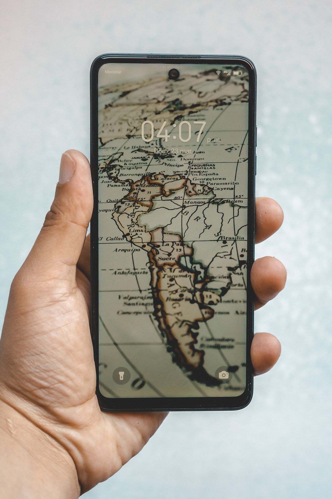 Smartphone in hand showing a map on the screen