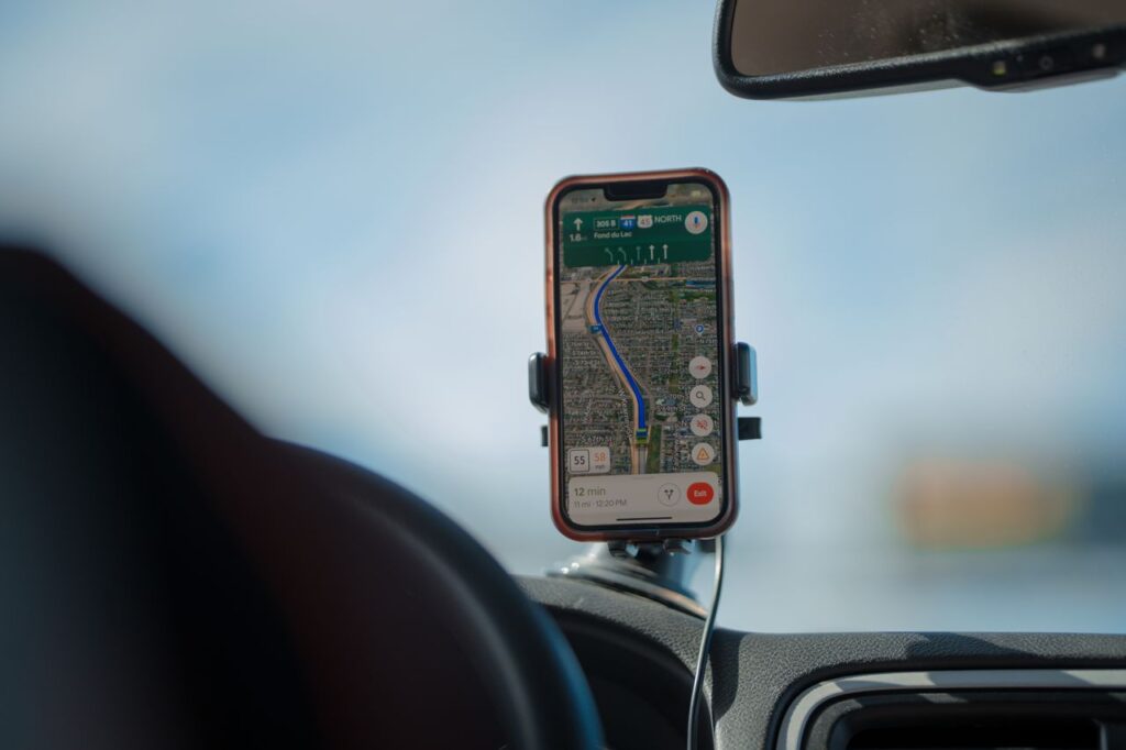 Smartphone running GPS navigation on a car dashboard