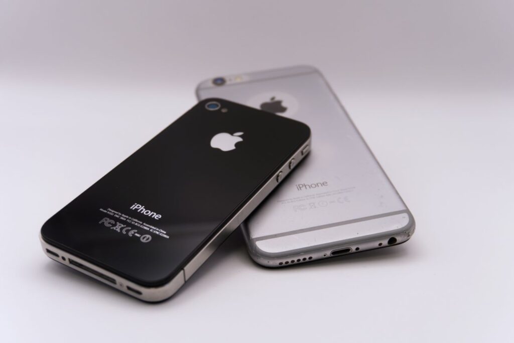 Two smartphones lying on a white surface