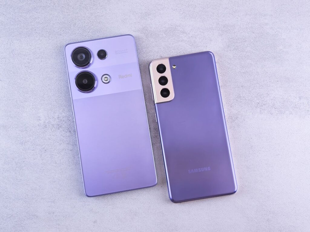 Two smartphones placed side by side on a light surface